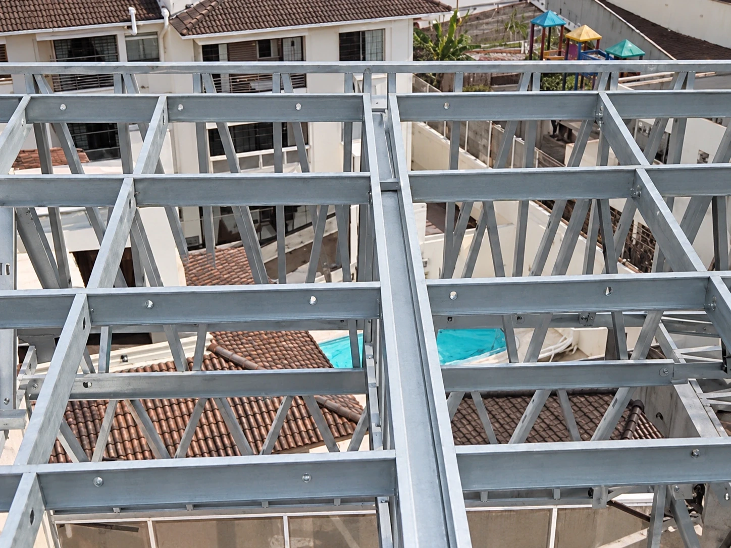 Grelha de steel frame com vigas treliçadas montada sobre o terraço de um prédio em Florianópolis
